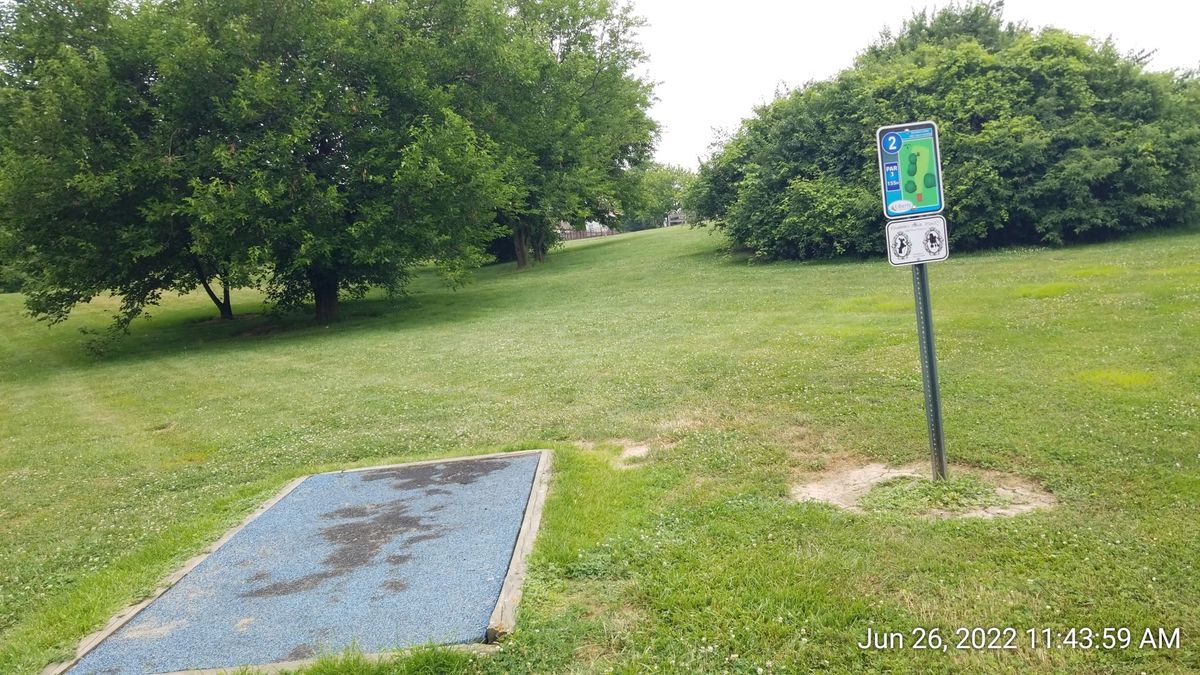 Basket for Hole 2 is ahead just behind the trees.  