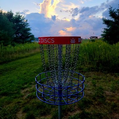 Hole 16 in silhouette against a gorgeous evening sky overlooking the soccer field back toward the middle school.