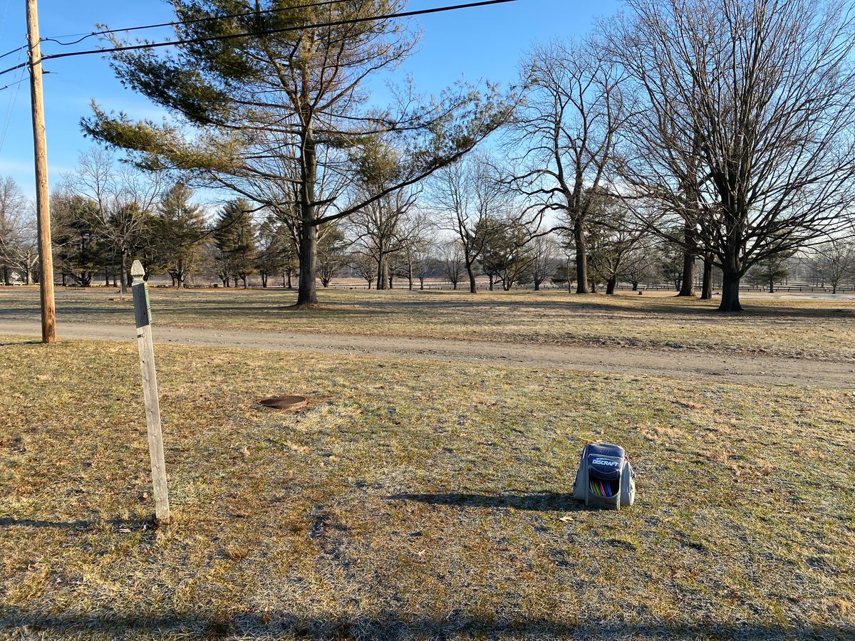 This tee and map have been removed; consider using the flagged tee 75 ft closer to basket. Little overview map shows old layout (was inaccurate on holes 1 and 2).