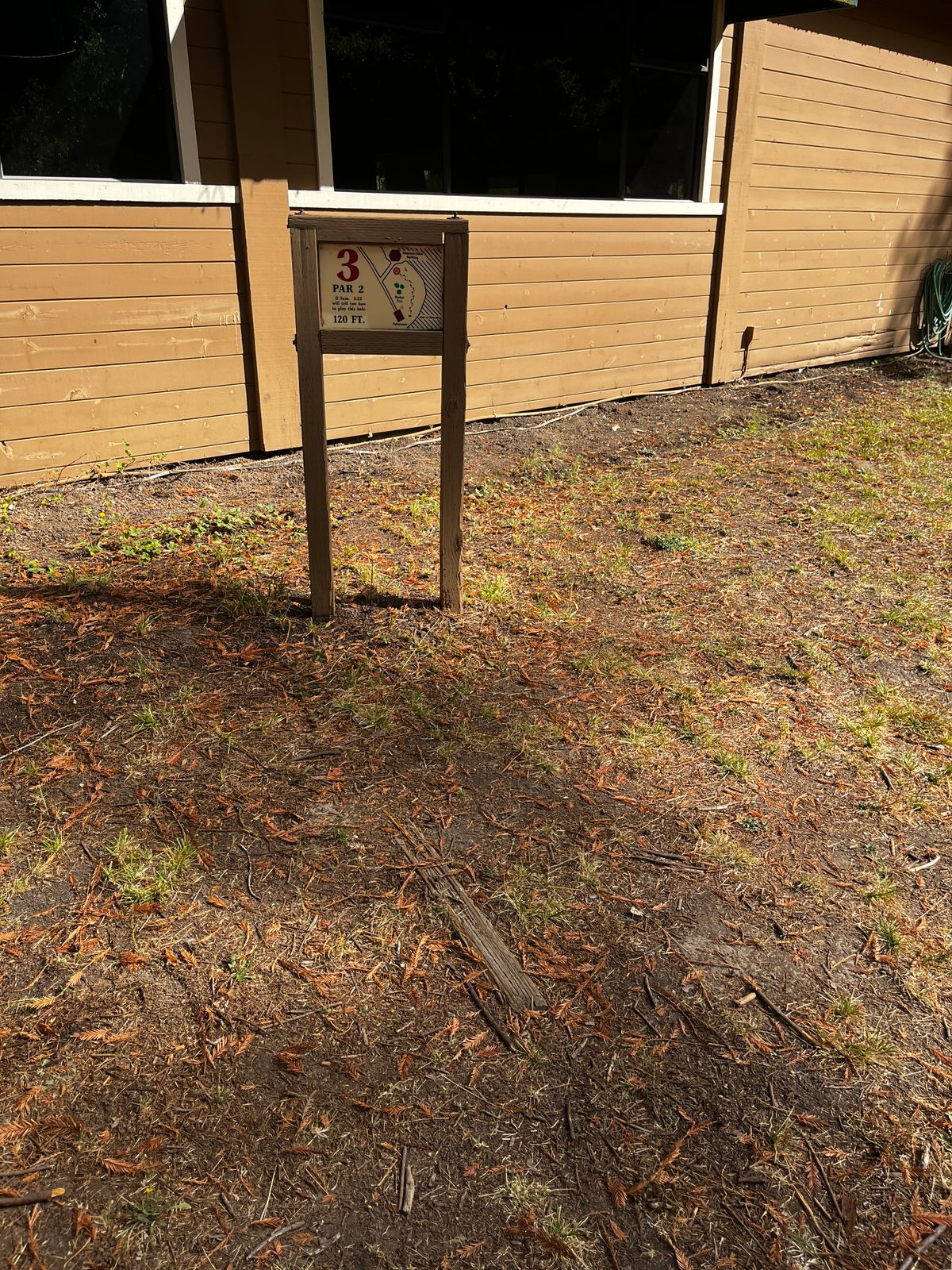 Hole 2 sign and “tee” - wood in the ground