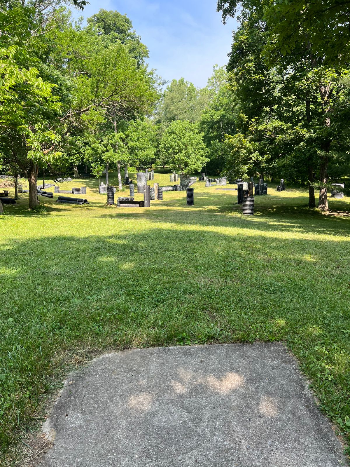 Hole 6 - Start from elevation and this hole throws over a paintball field, the basket is on a peninsula to the right side. As long as the creek is down the danger here is low.  Can you put a disc in one of the tall towers... yes it is possible.