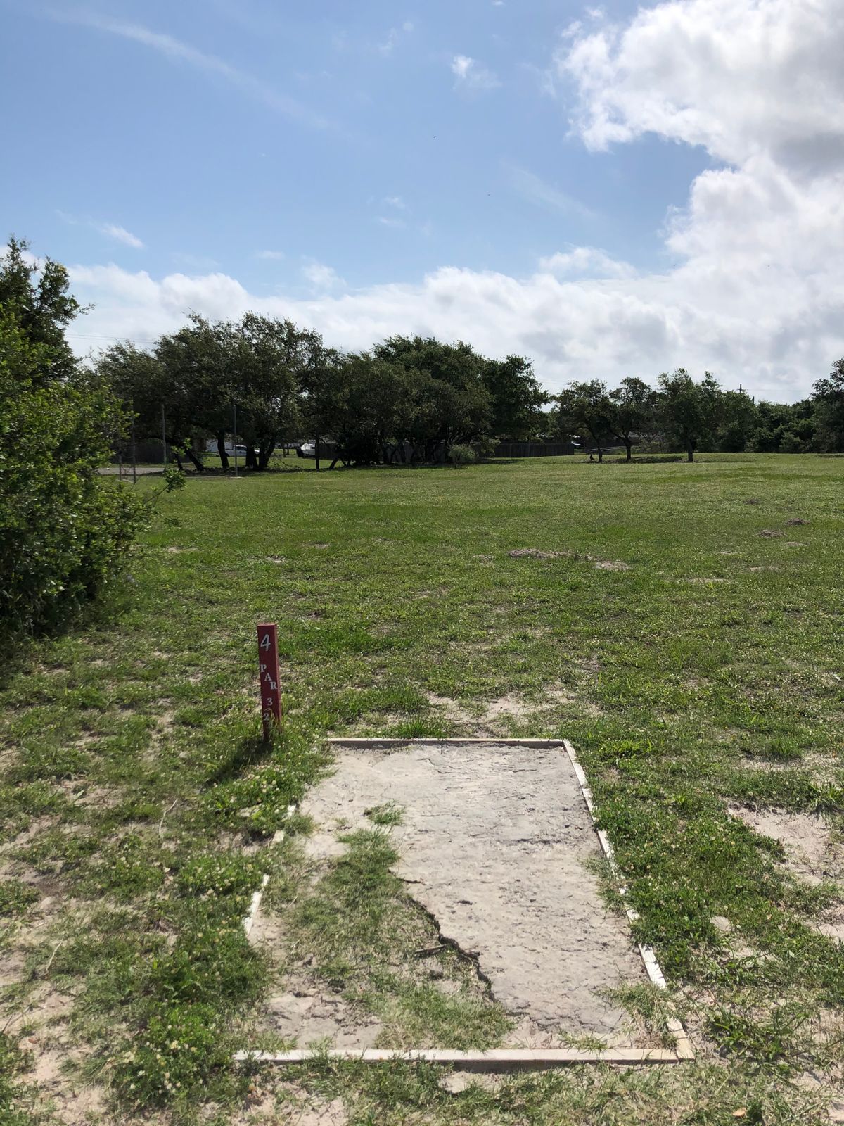 Red tee box for number 4. Basket is in all the tree straight ahead.
