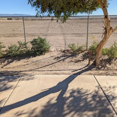 Intentional opening in the fence to retrieve discs.