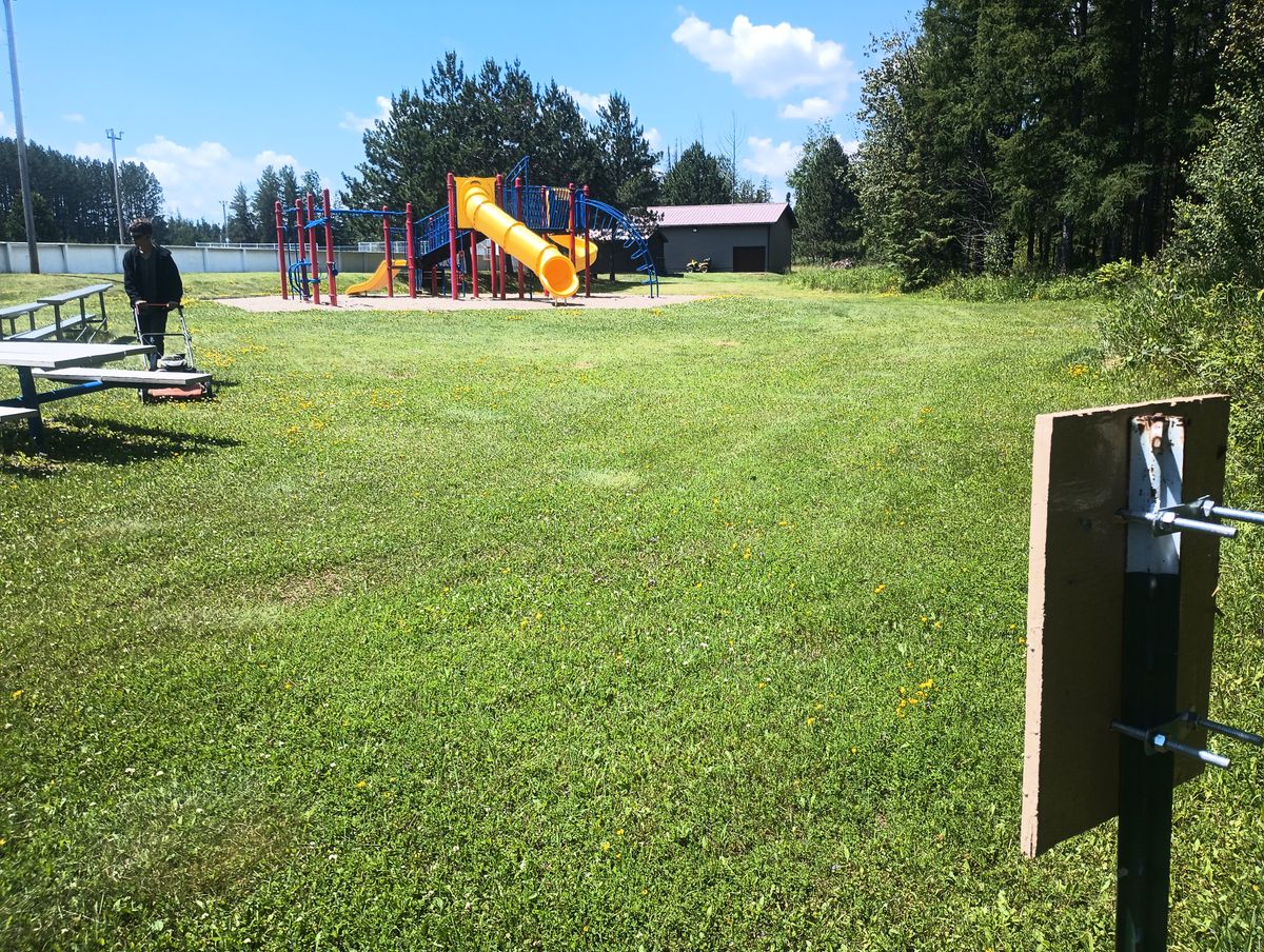 The basket on hole six is behind the playground. This phone is from the tee