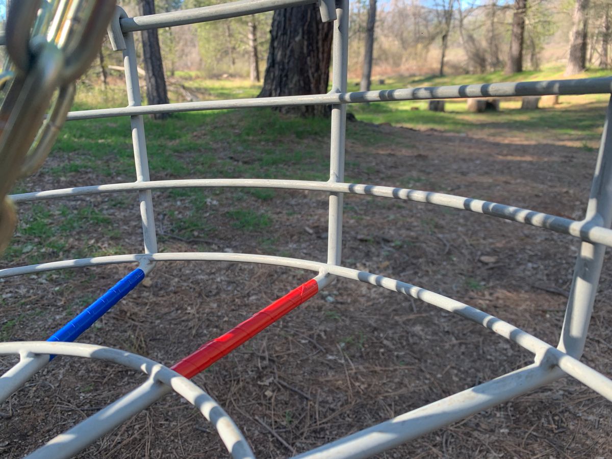 Red and Blue tape on each basket pints to the next red or blue tee box