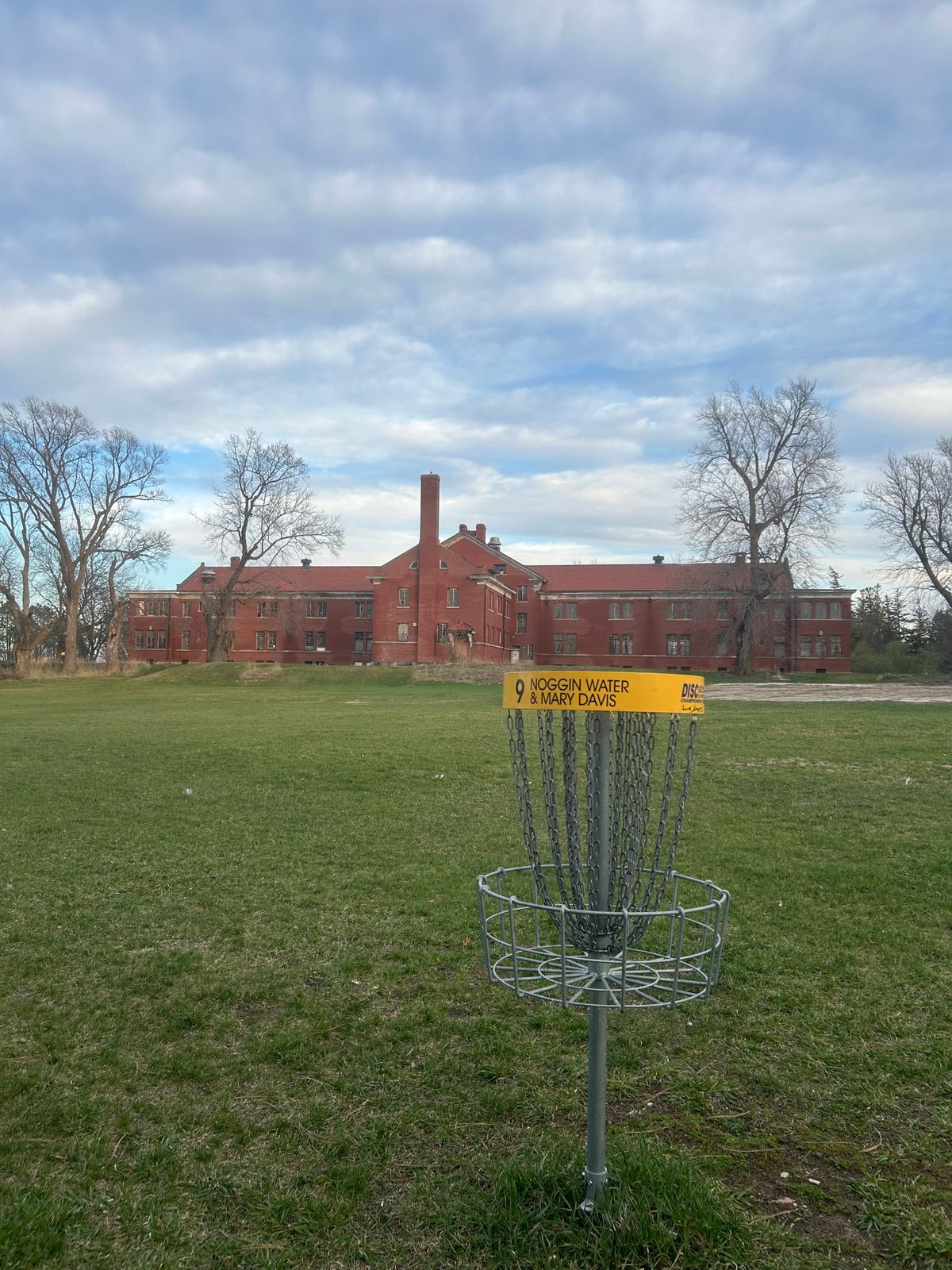 Hole 9s basket overlooking an old building