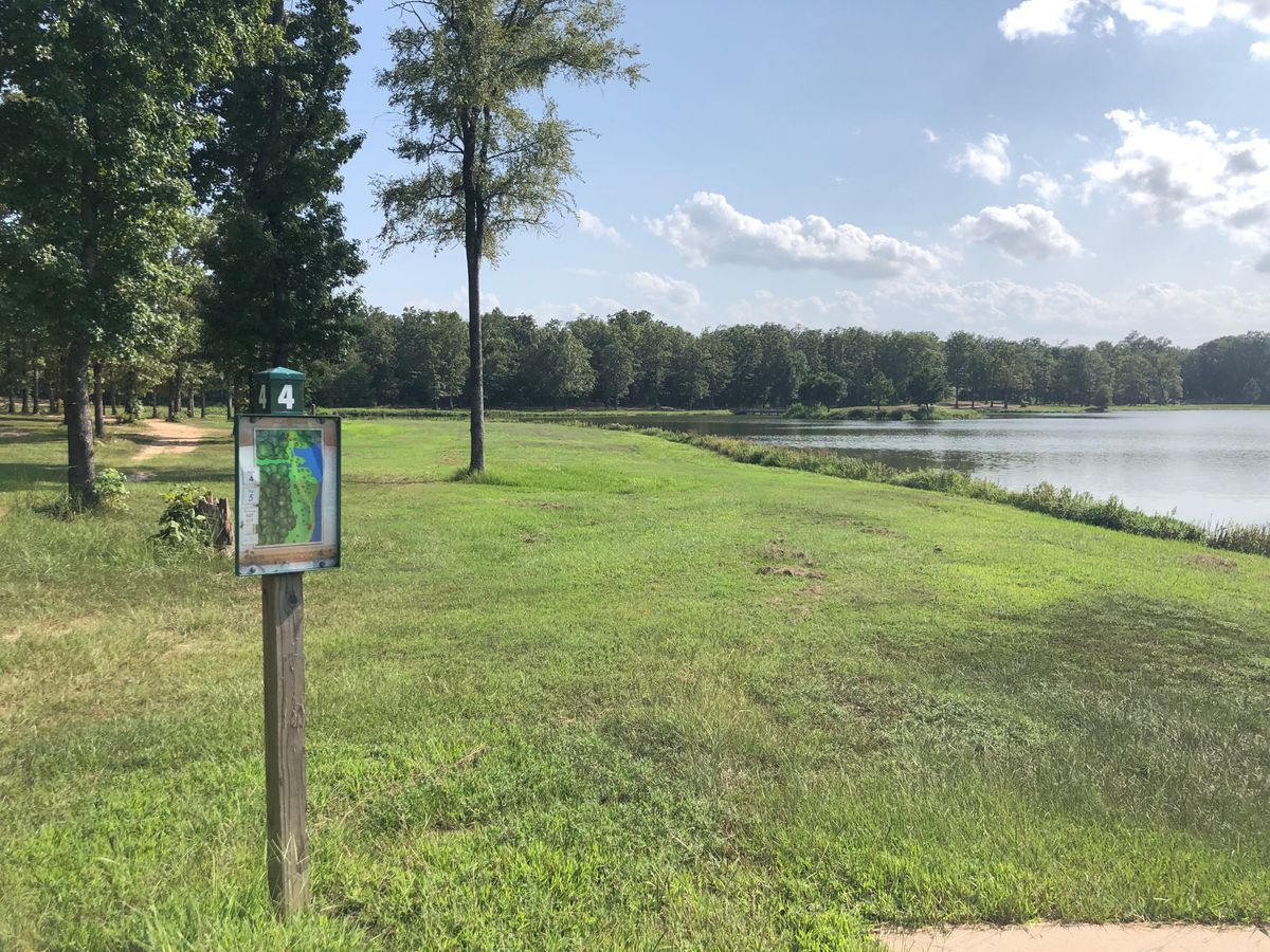 Hole 4 Red tee box, fairway bends right, water in play