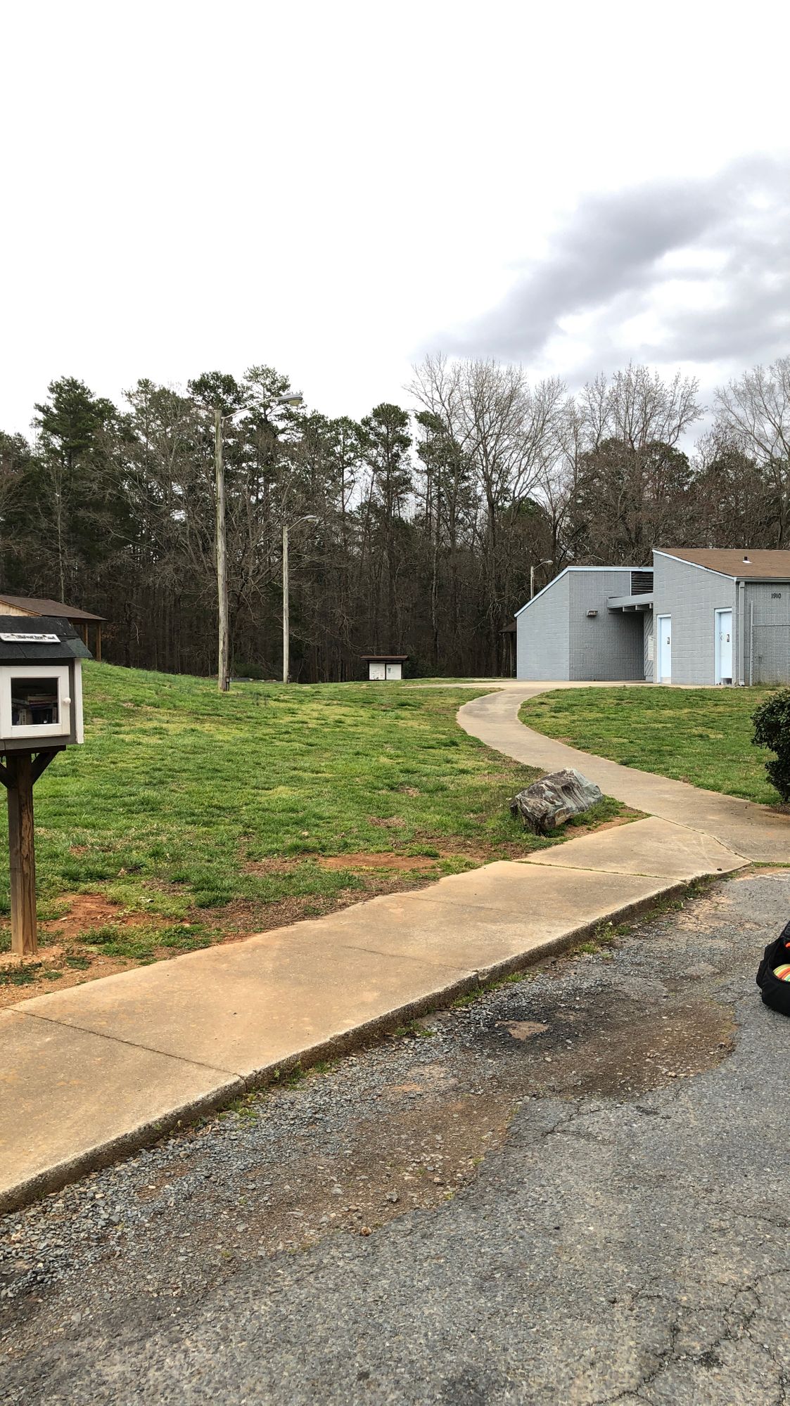Walk between pool house and tennis courts to get to the course.