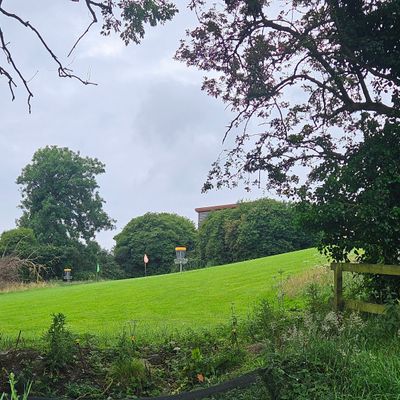 This is the tee for hole 5, you can see the baskets for 6 and 8 in the distance, hole 5s basket is out of shot to the left.