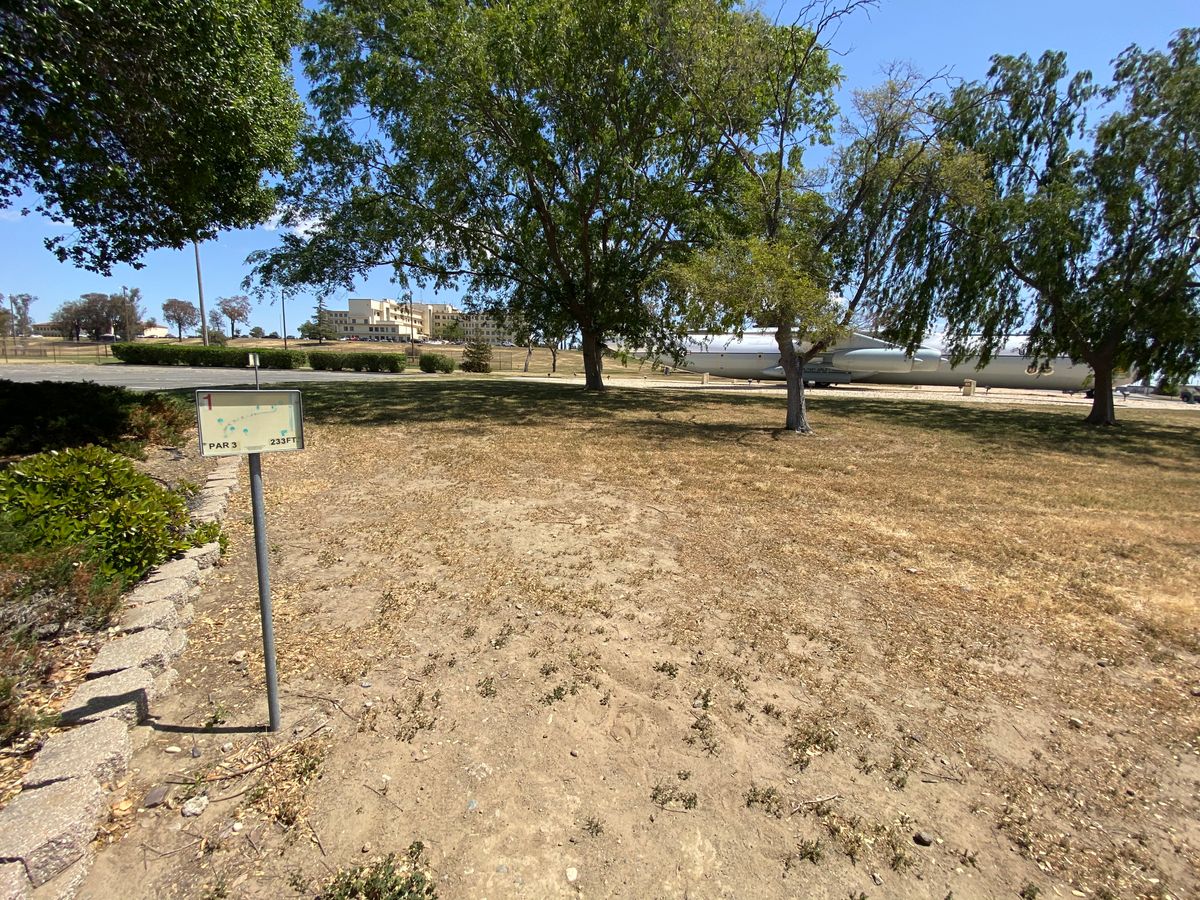 Hole 1 basket straight ahead past airplane