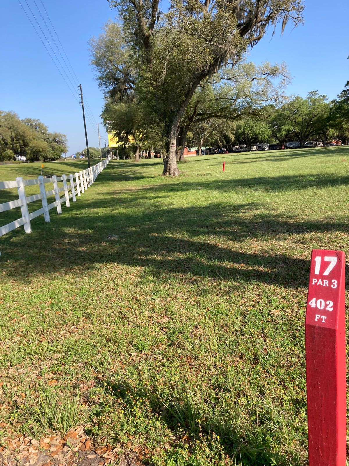 Hole 17
There’s a mando right sign, on the second big tree in the fairway