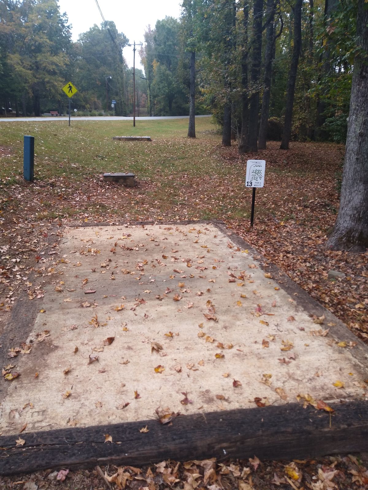 Teebox and fairway. Curves hard uphill after bushes on the right side.