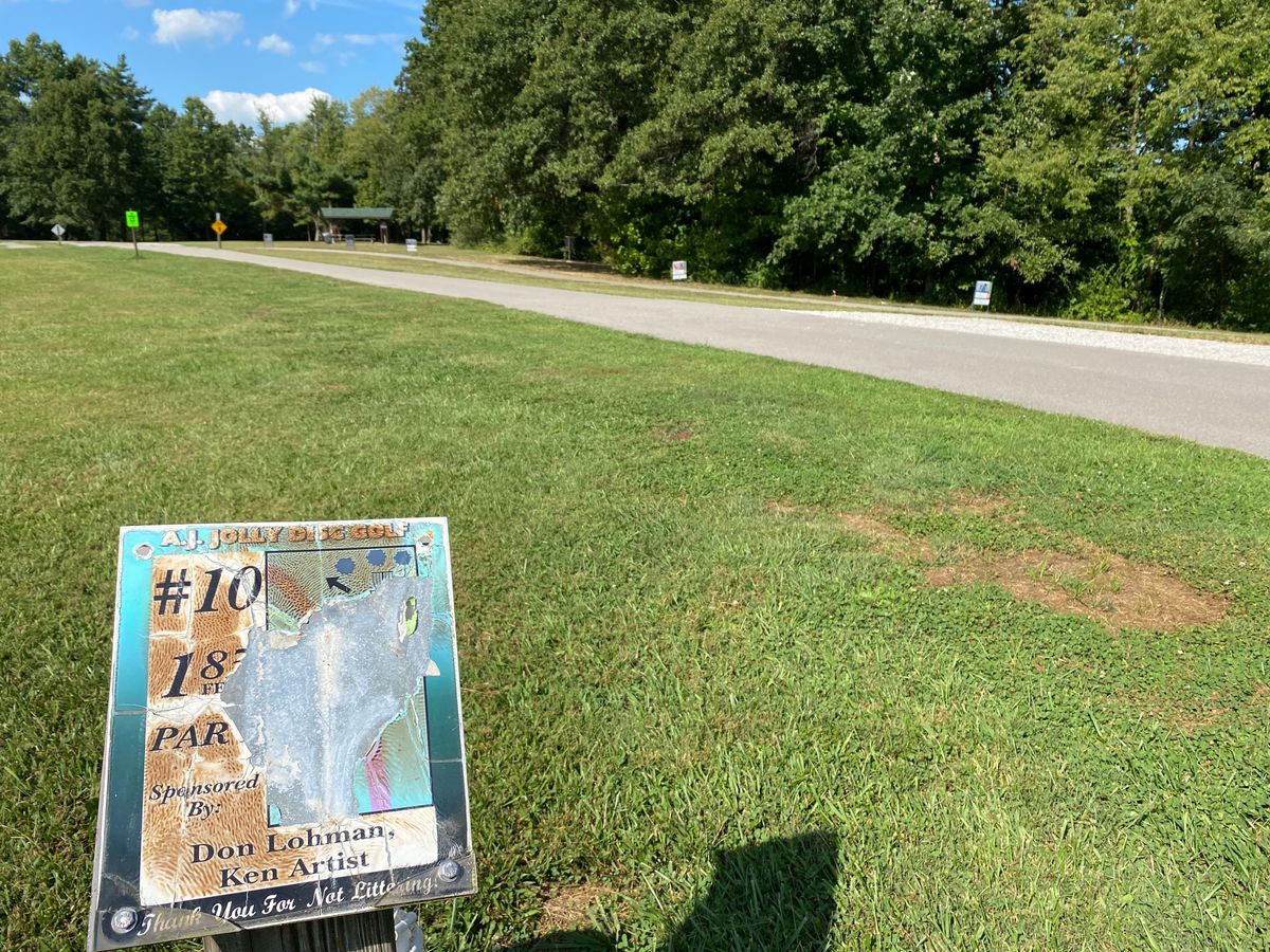 Hole 10, taken 9/4/2023.  Sign damage, extremely short distance to basket just under the woods edge.