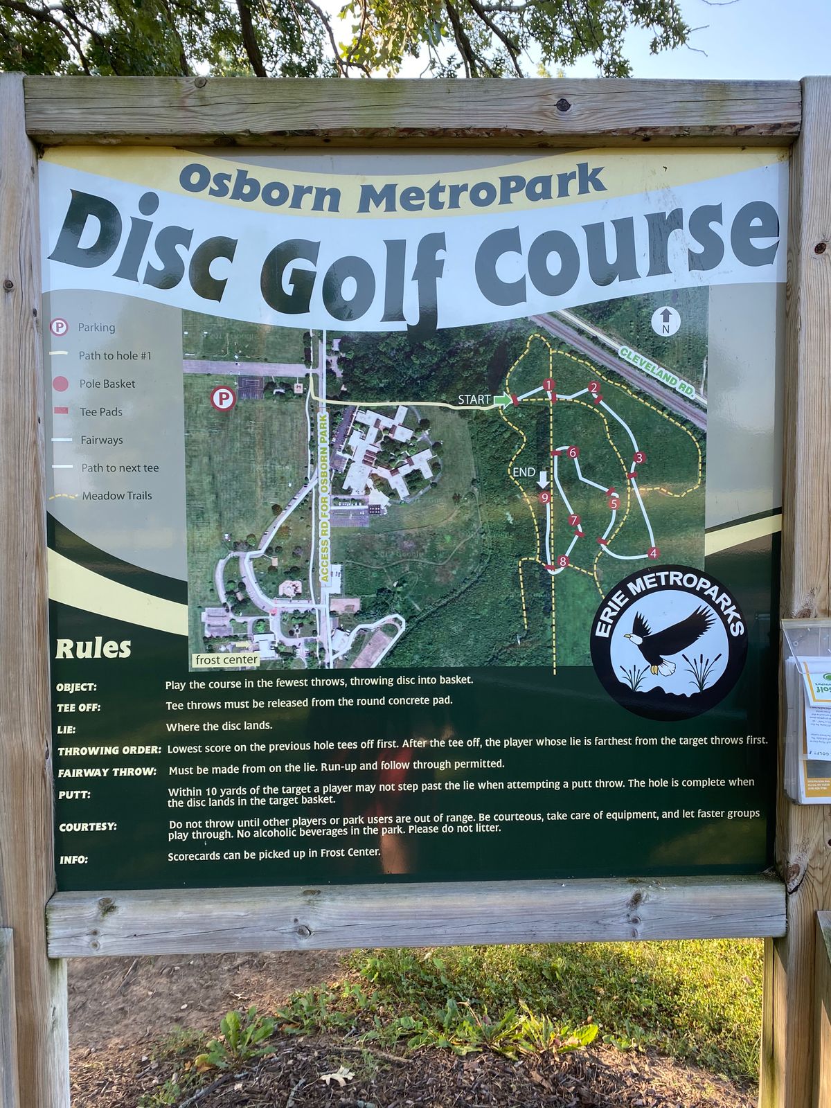 Walk towards the school (right of this sign). You’ll see a path before the school. Path leads to One