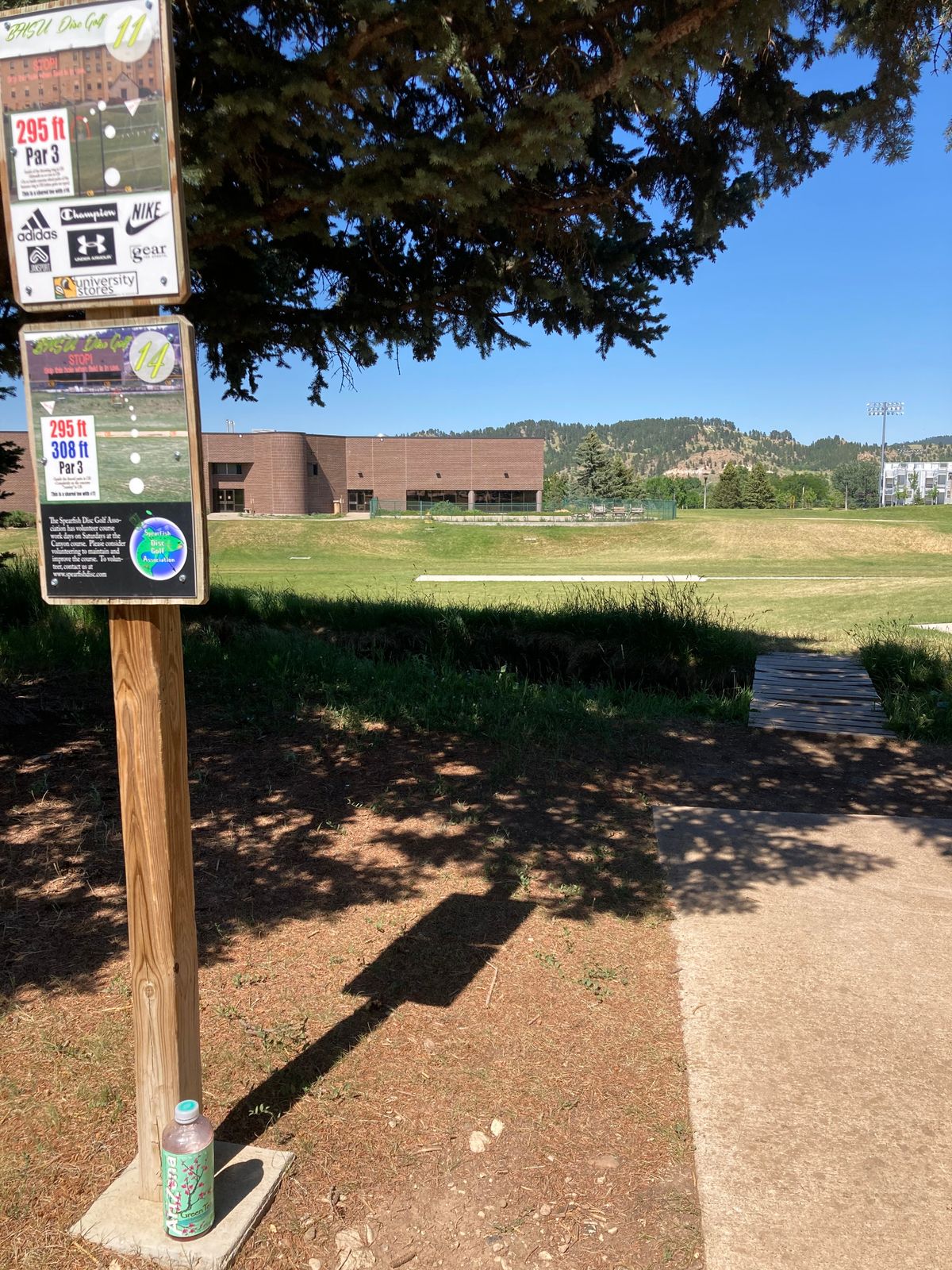 Tee 14- sharedpad w/ 11, 14’s basket towrd this building/ fence