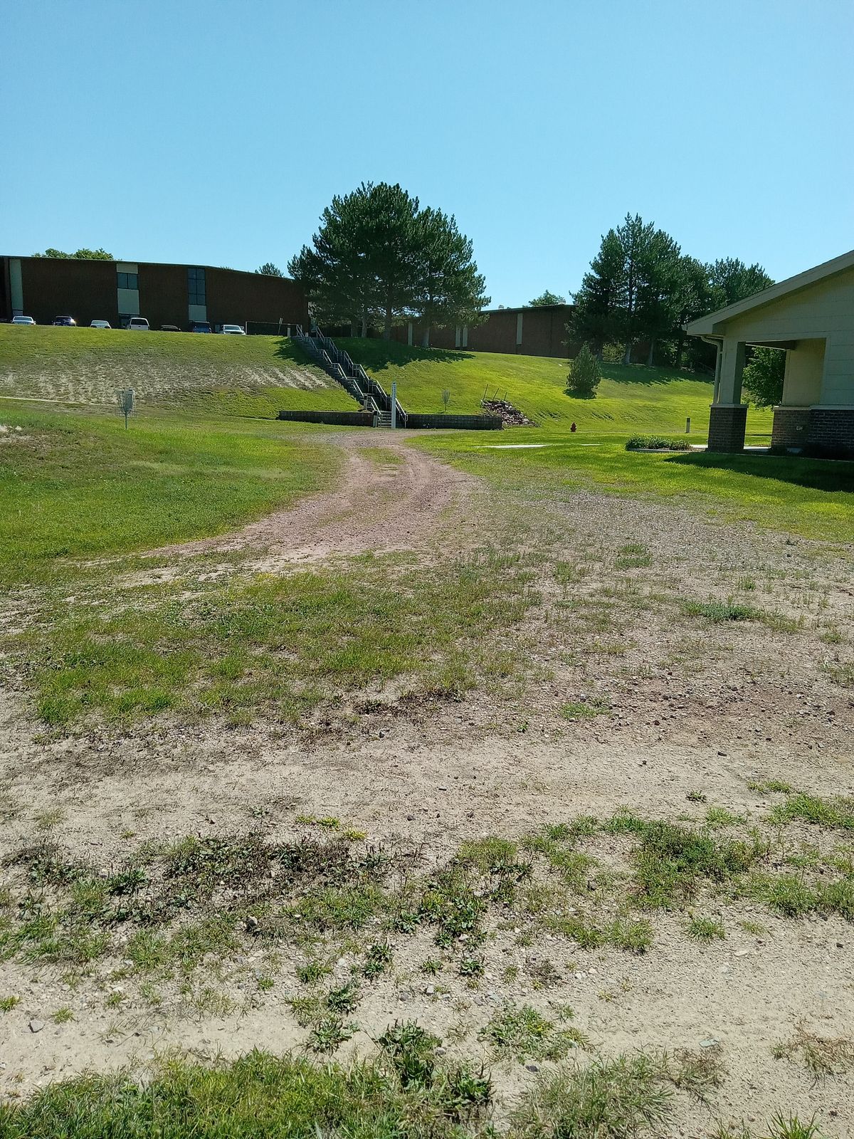 Neo Layout hole 4. Tee off from dirt path to basket #4 (white number on basket.)
