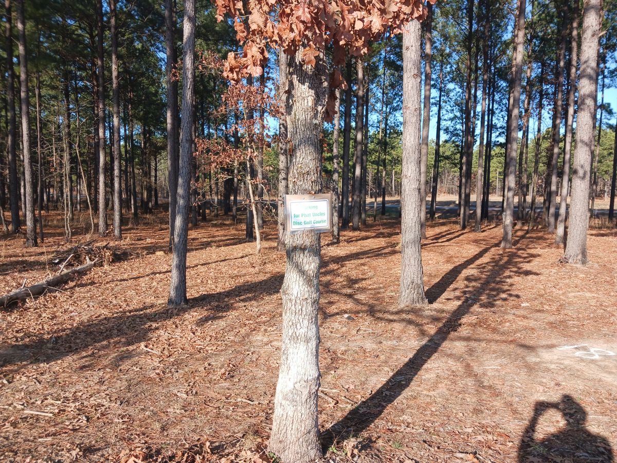 Parking area 200ft west of gate.  Near #18 tee box.
