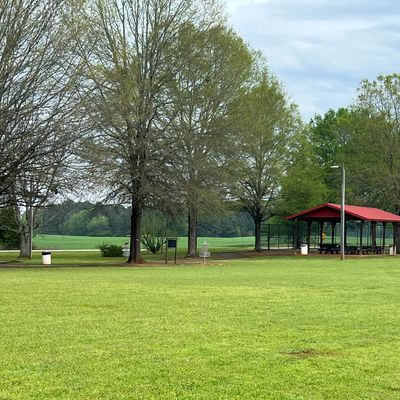 Hole 4 tee pad. Fairway open across field. Avoid the OB walking path behind the green.