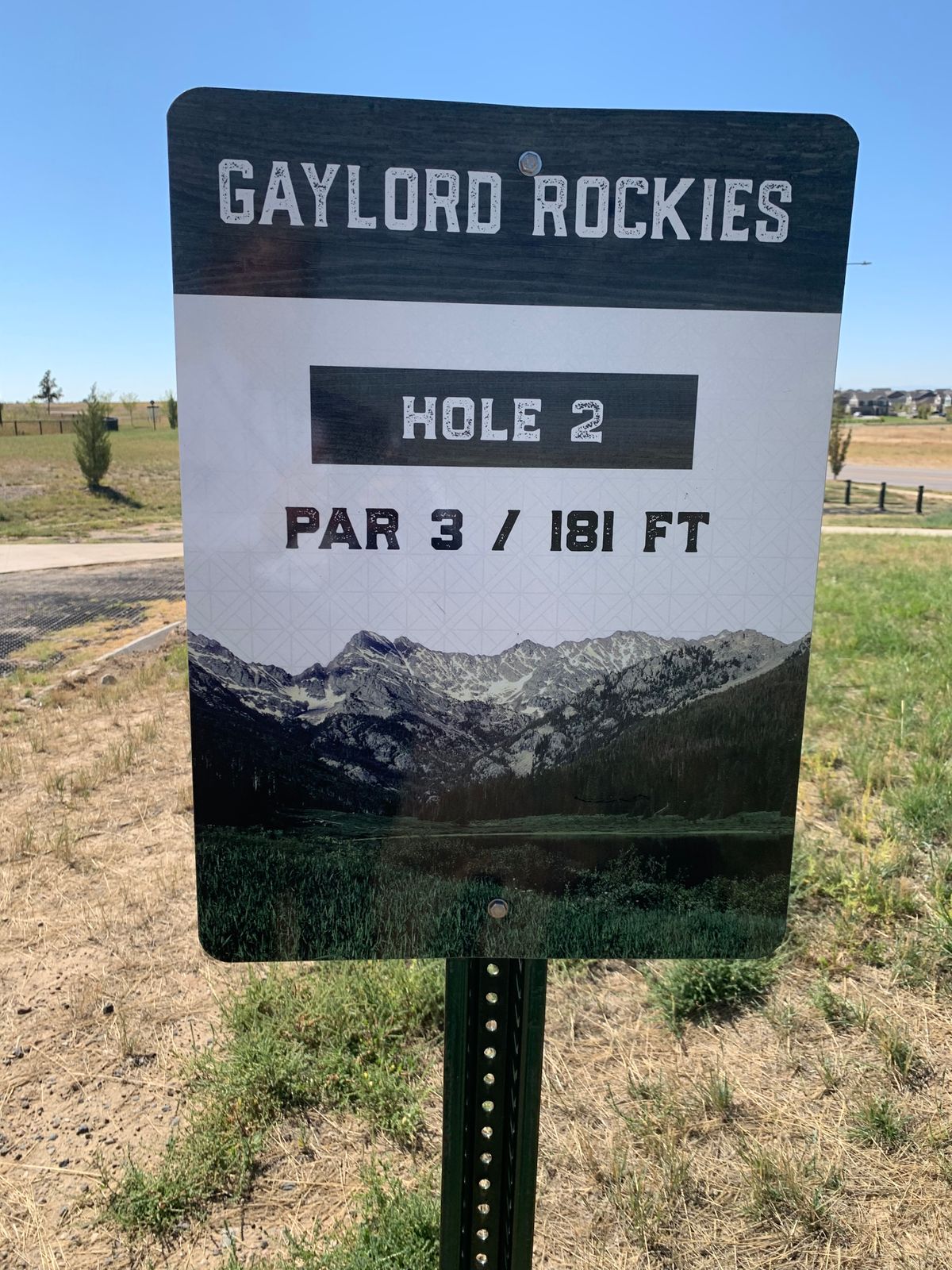 Tee off from reinforced dirt/grass area. Watch out for the pool fence on the left.