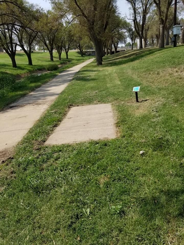 Hole 16 tee pad up and to the right near the intersection.