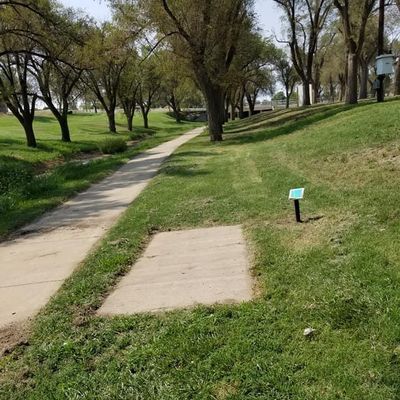 Hole 16 tee pad up and to the right near the intersection.