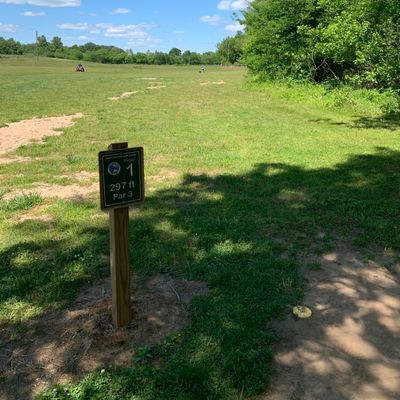 Hole 1 - Creek along the right side with a thin, but dense layer of woods as a buffer.