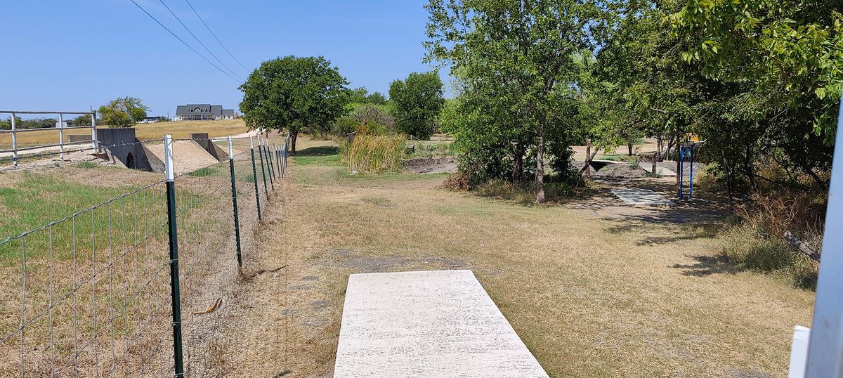 Hole 14 tee pad, anything over the fence is ob, you can not go over the fence to get your disc back. Most are returned to the pro shop.