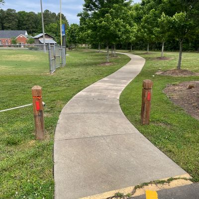 First tee. Follow path and trees to basket. Playing field to left is OB.