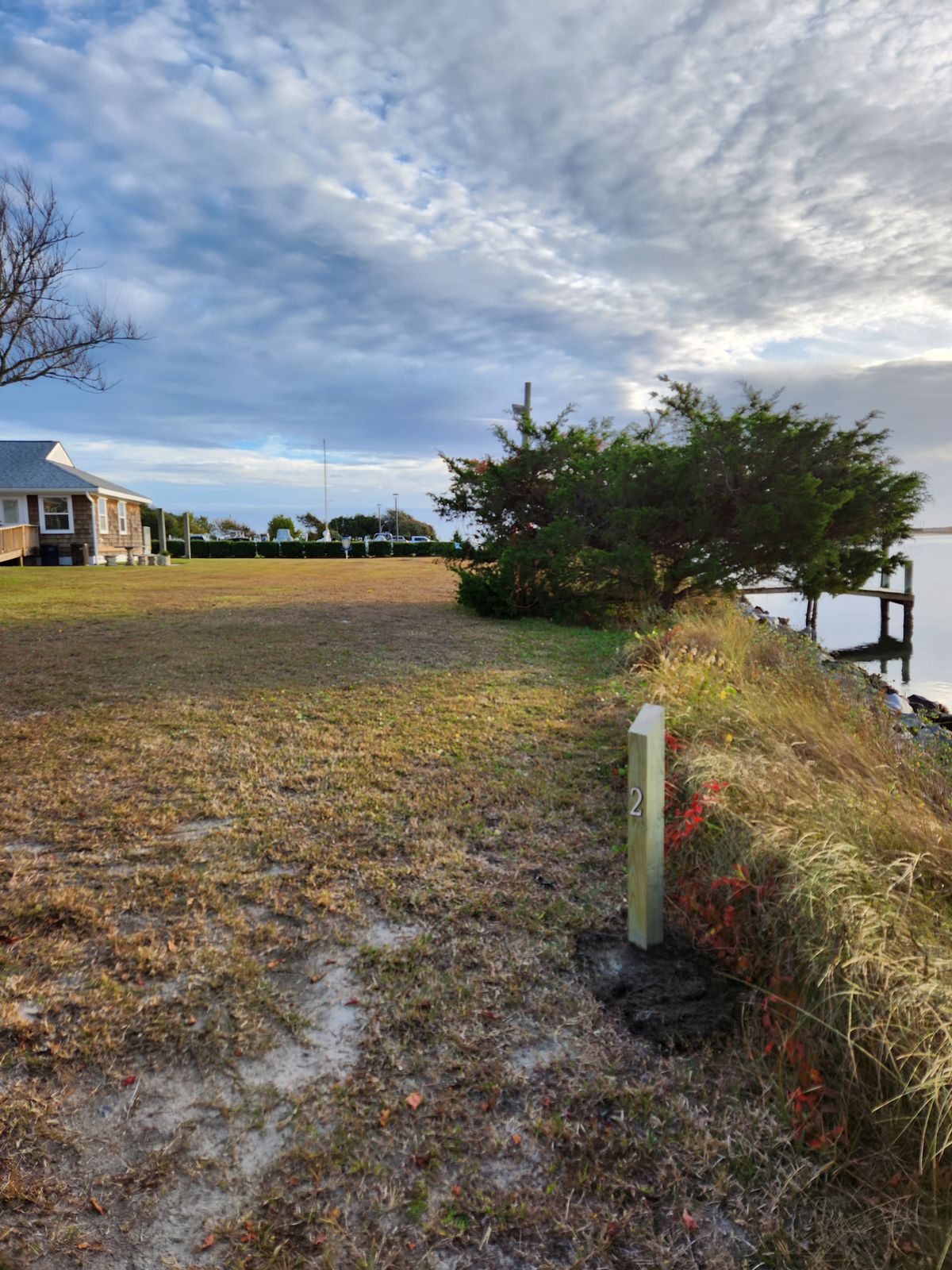 WATER HAZARD, USE CAUTION WHEN WINDY! Skip hole or tee from alternate tee pad by the dock if it's windy.