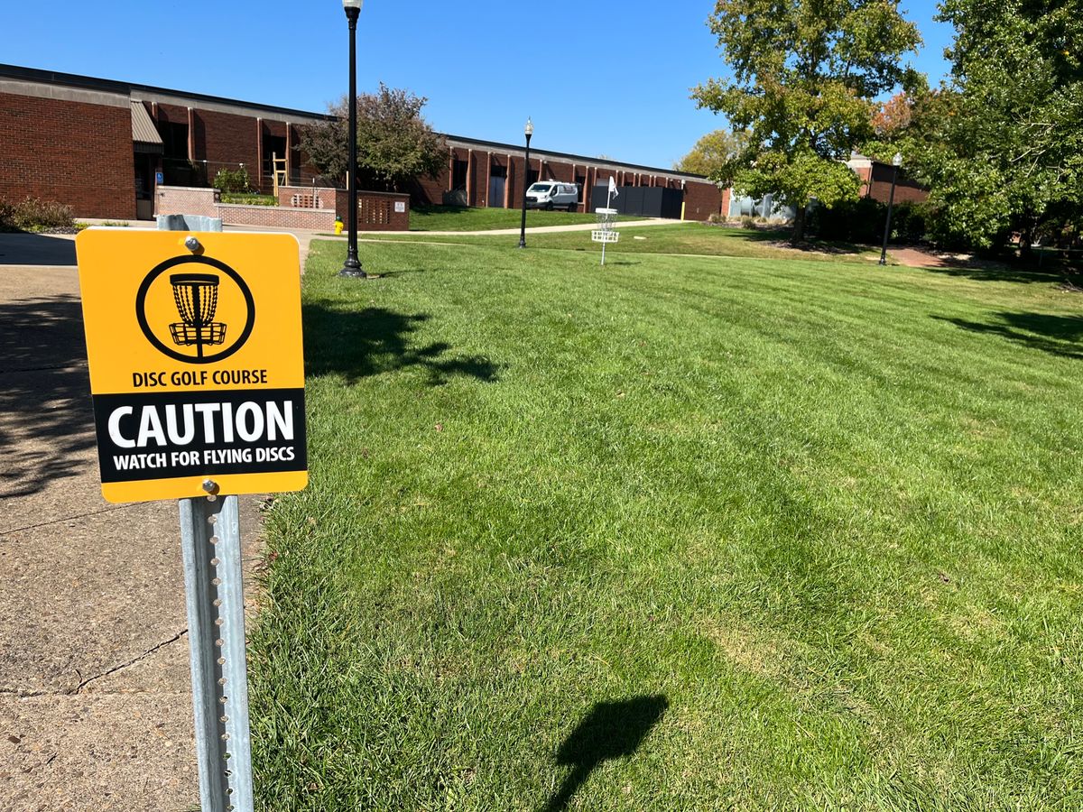 Caution watch for flying discs sign on hole 8