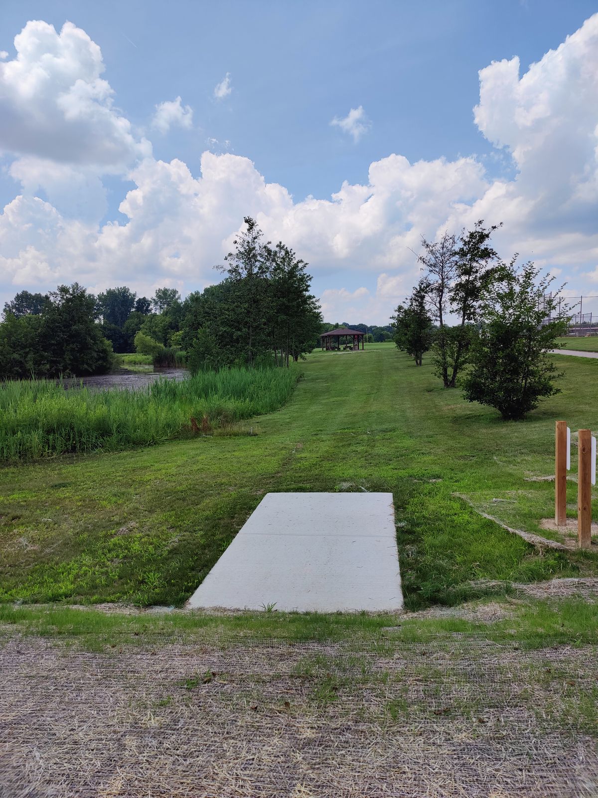 Hole 1 - 266 ft - Par 3 - Late Left Turn - Water Hazard Left Side