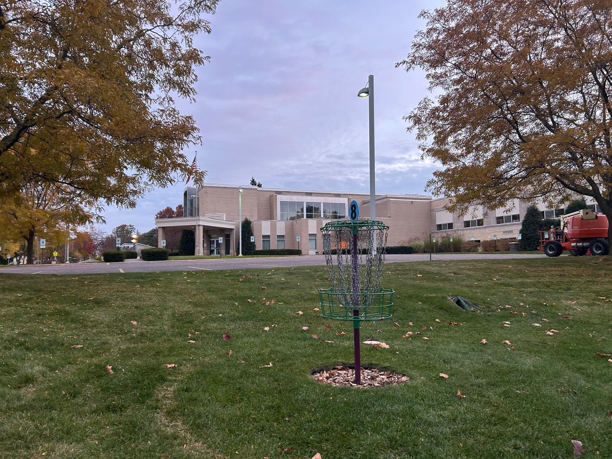 Hole 8 basket with front of school