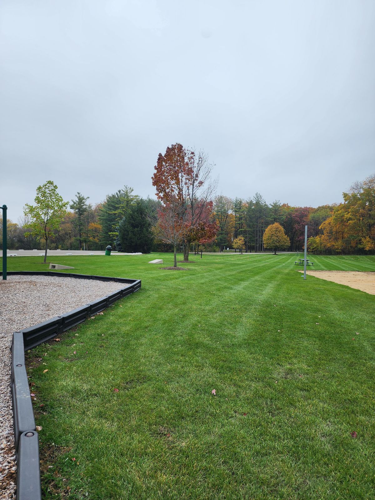 View from hole 1 tee. No tee sign. Teeing area behind playground.