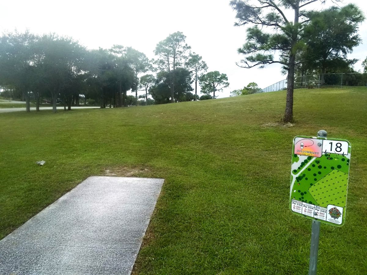 White pads #18  Careful of dog park on right and trees and road left.