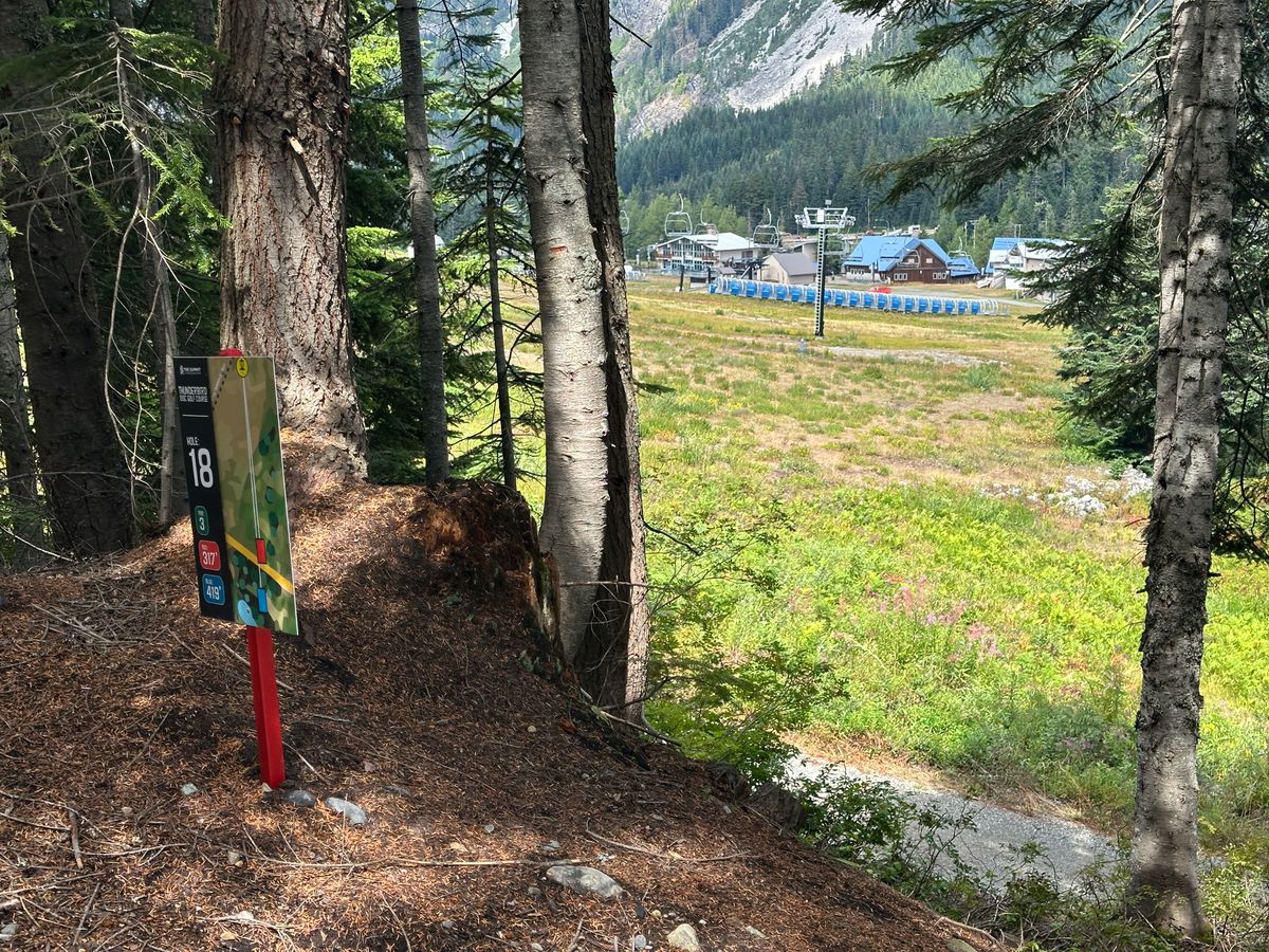 View from Blue tee box of Hole 18 (basket just left of base of the lift post in distance).