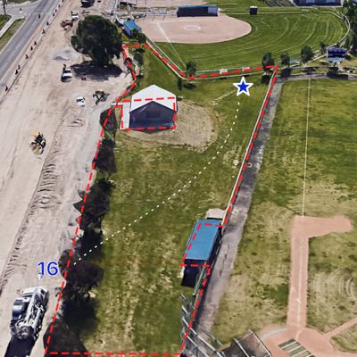 Tee on asphalt pathway underneath tree. There may be spray painted line there. Ob road and baseball
