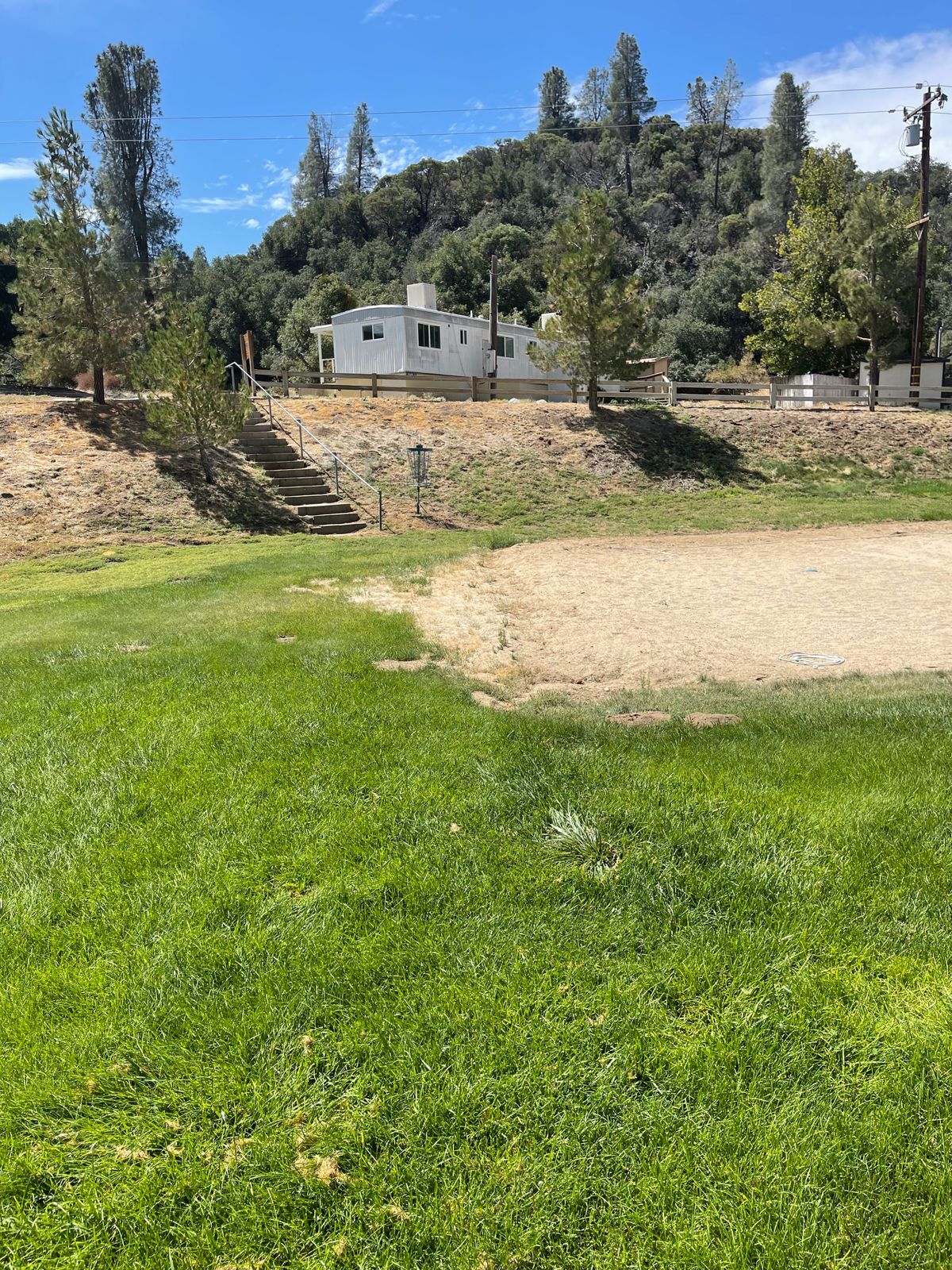 Hole 11 is at the bottom of stairs.  Same basket as hole 7 on front 9