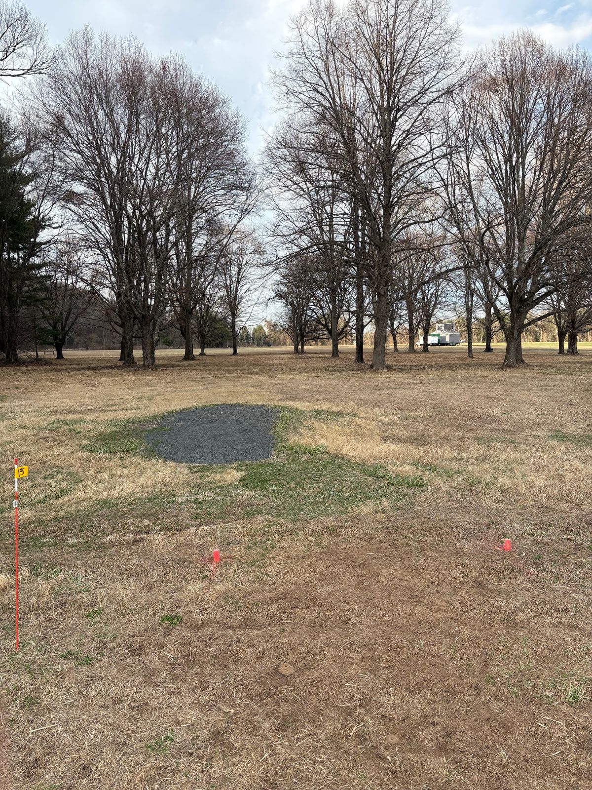 Proposed hole 15 is directly right and back of the gravel pad.