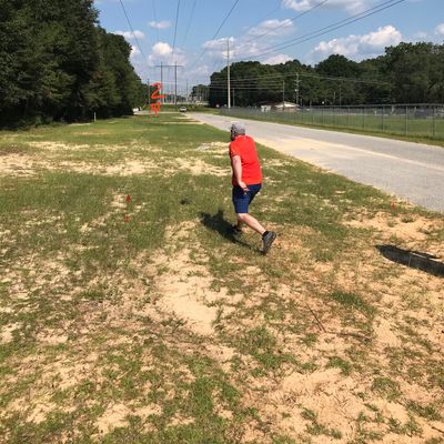 Hole 2: triple island. OB road on right and two dirt roads running horizontally in fairway