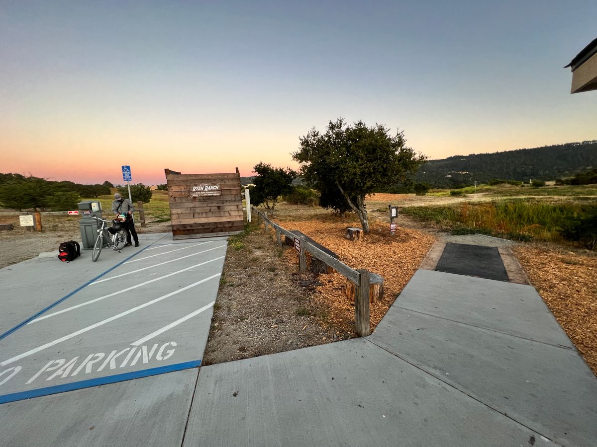 ADA Parking, Port-O-Potty (behind the wall), new handwash station, and Hole 1’s tee pad. 
