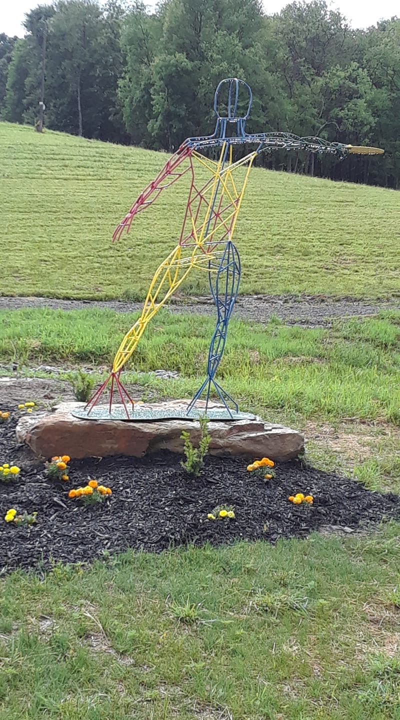 Frisbee Thrower statue points the way.