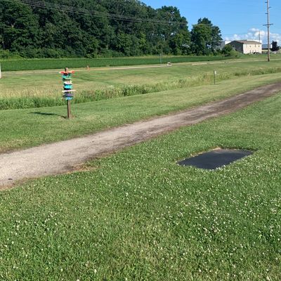 Tee pad 1. Next to quirky sign.