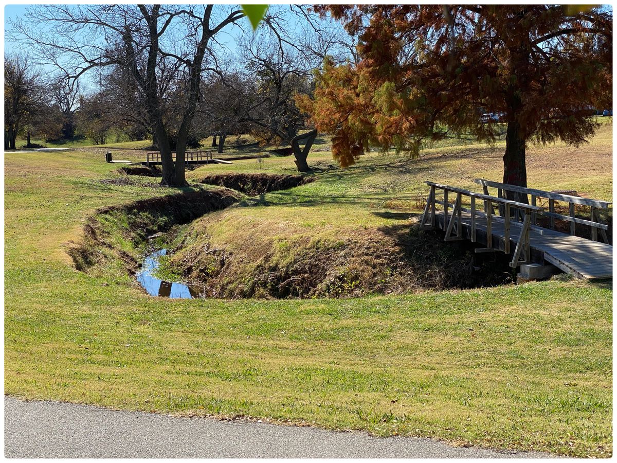 #13 Tee is sidewalk- throwing south- have to pick which side of creek you want to land on