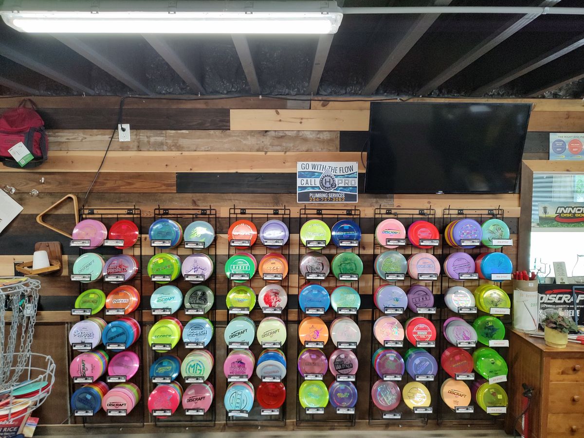 Wall of discs available for purchase within the Pro Shop.