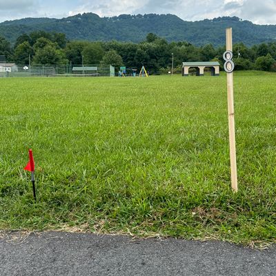 Goes across field near playground