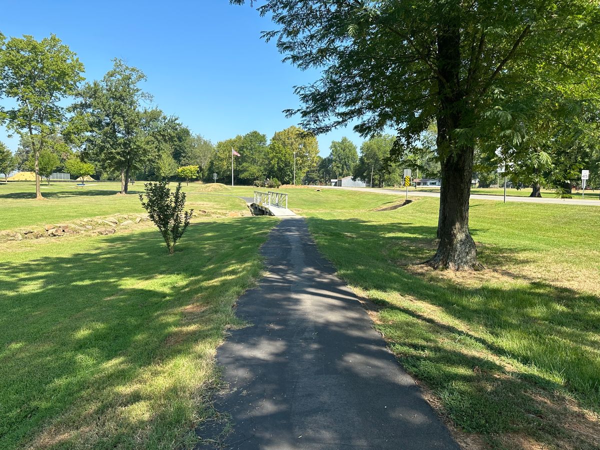 Path to the bridge leading to the basket on a hill hole 9 Mulberry Arkansas Disc Golf Course