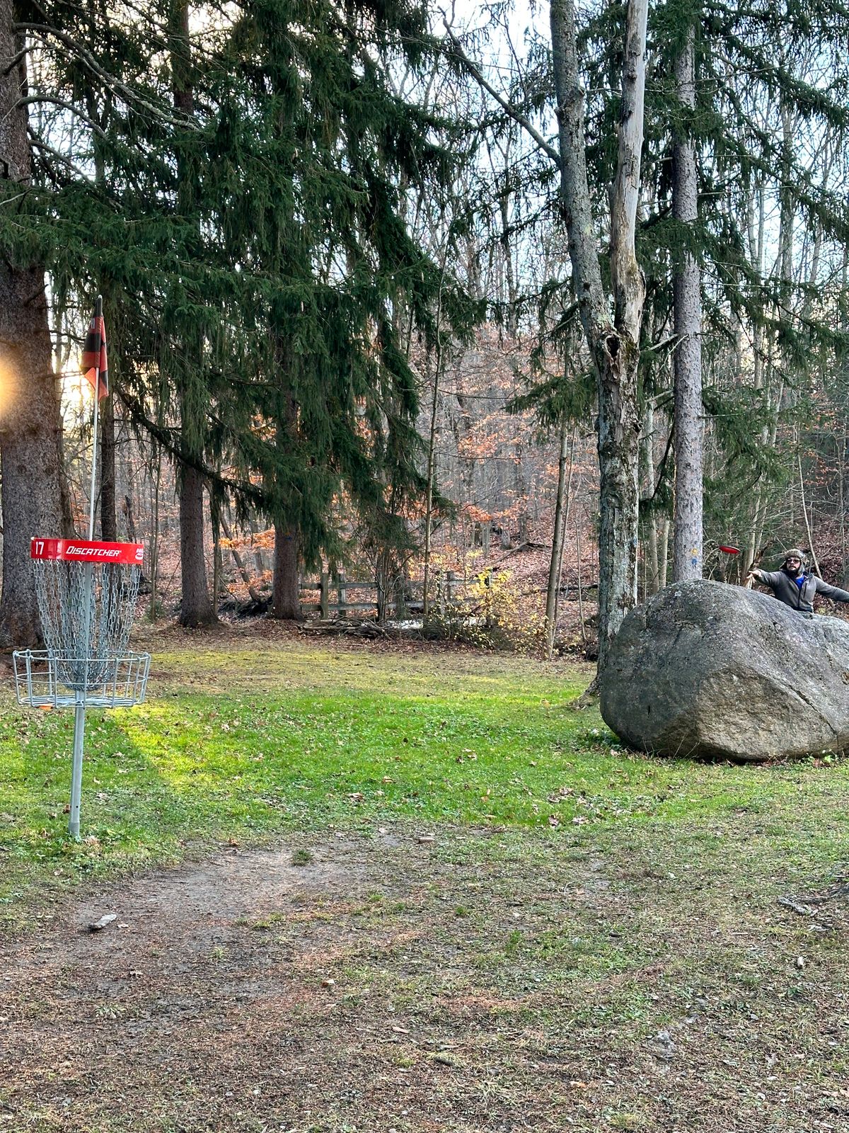 a boulder offers partial protection of hole 17’s green
