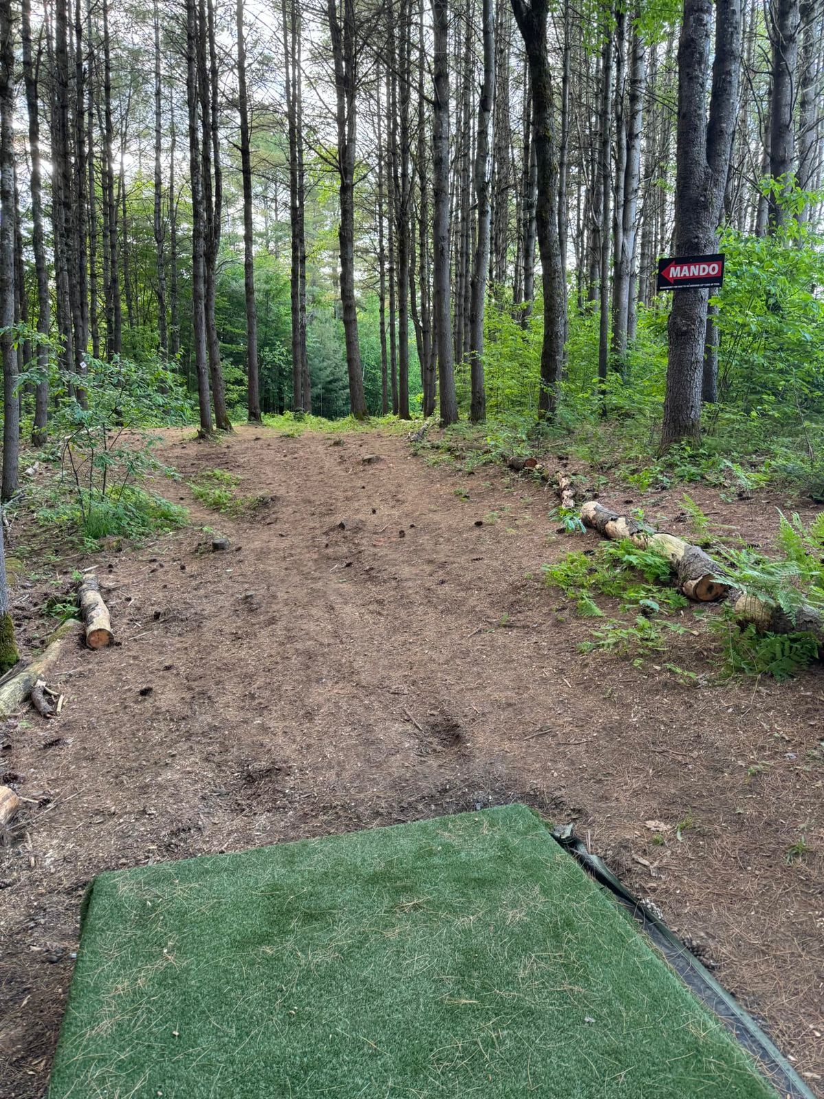 This is the new tee deck location for number #18. It was moved up the fairway slightly and changed to a par 4 to accommodate the new basket location.

Note the Mando left on the fairway.