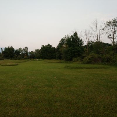 Hole 16 fairway after the bushes center from tee