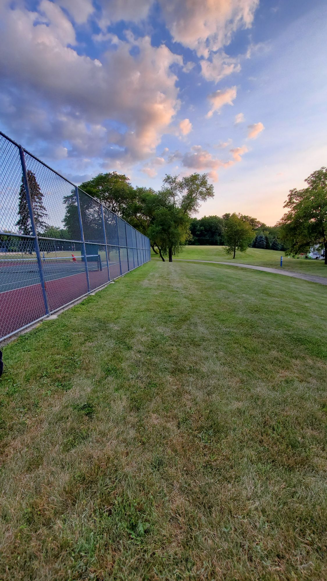 Alt 8 Tee
In ling with the second poll from the corner of the tennis court fence.